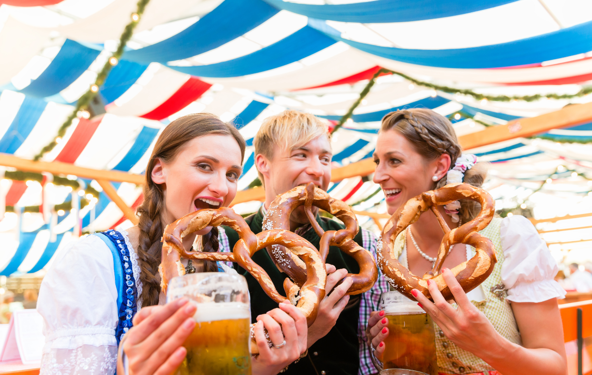 Festival-goers in the biergarten tent with pretzels and beer