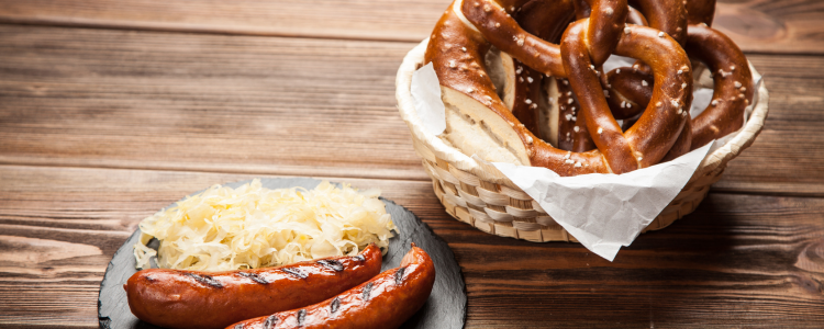 Grilled bratwurst with sauerkraut and a basket of soft pretzels