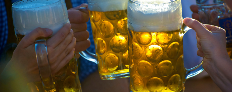 Steins of craft beer raised in a toast